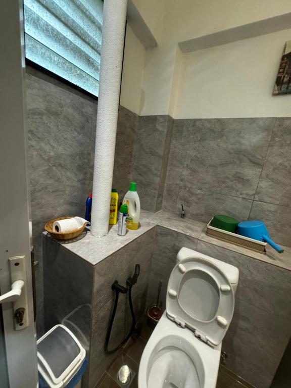 a bathroom with a white toilet and a sink at Room in Bayanlepas in Gelugor