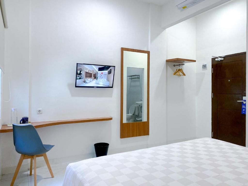 Postel nebo postele na pokoji v ubytování Cordex Hotel Marelan Medan
