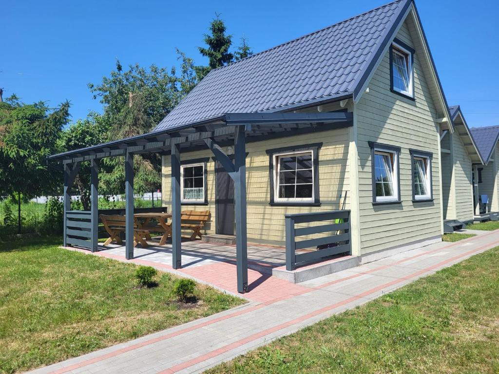 a house with a gazebo in a yard at Domek 7 osobowy piętrowy in Stegna
