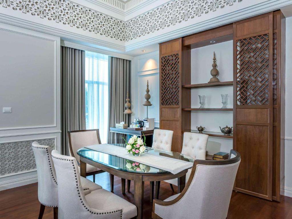a dining room with a table and chairs at Novotel Phuket City Phokeethra in Phuket Town