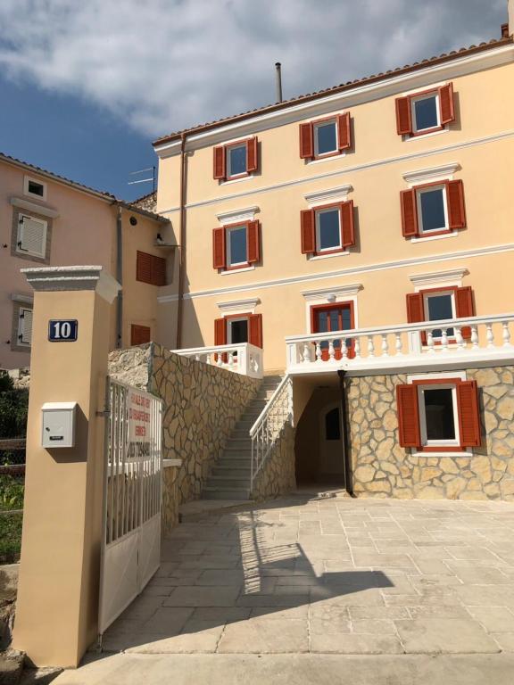 a large building with a staircase in front of it at Romantic Villa Centar Omisalj in Omišalj