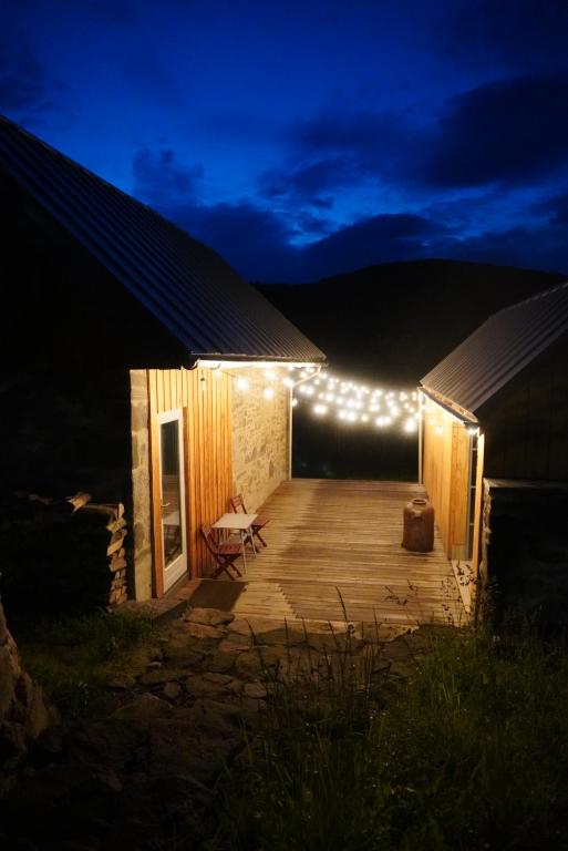 a wooden deck with lights on the side of a building at Stodola Počúvadlo in Počúvadlo