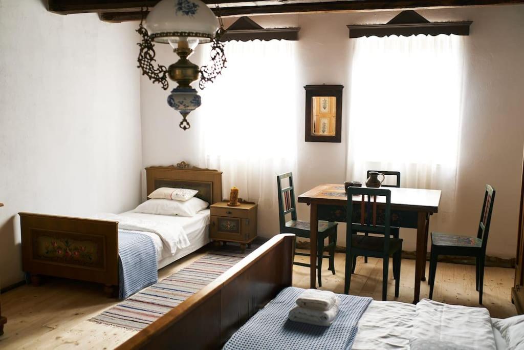 a bedroom with two beds and a desk and a table at Casa Klein in Meşendorf