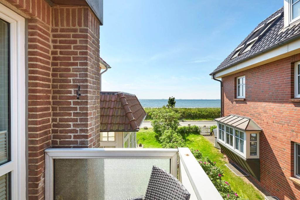 a balcony with a view of the ocean at Pidder Lyng 1 OG in Wyk auf Föhr