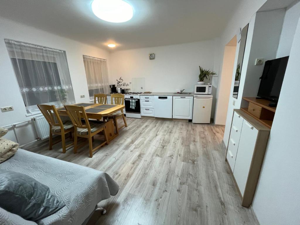 a kitchen and dining room with a table in a room at Rene Stay Naisiai in Naisiai
