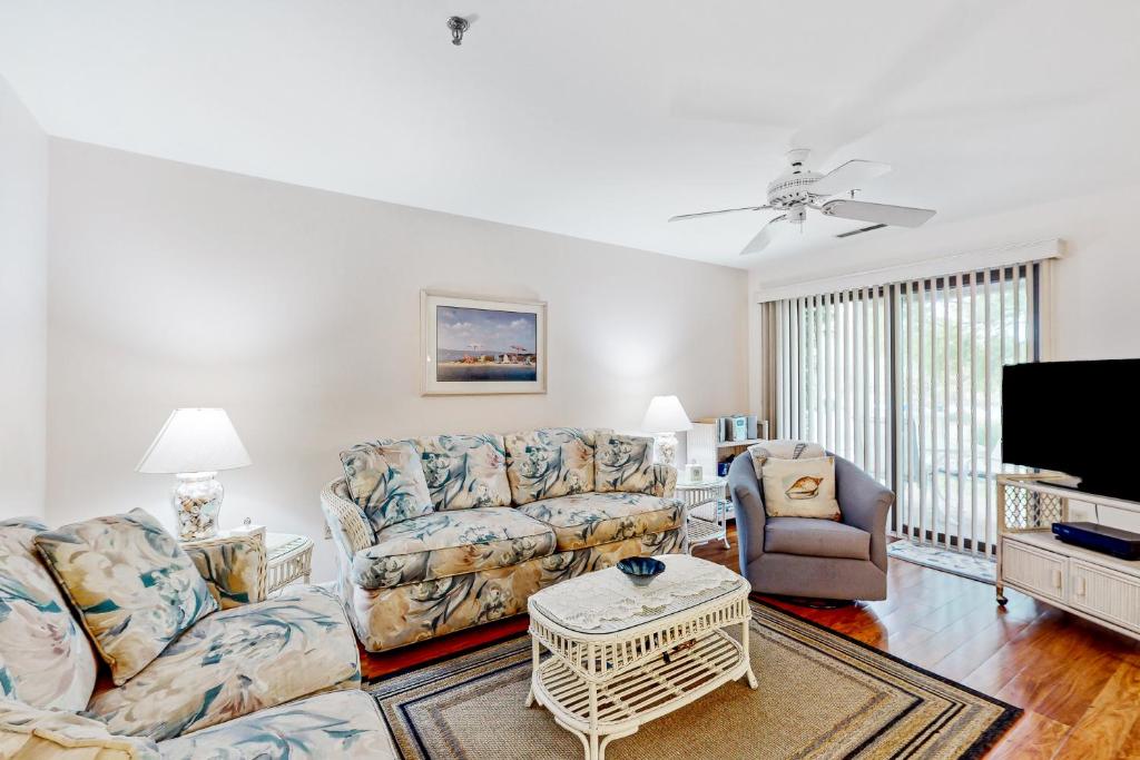 a living room with a couch and a tv at Spring Lake --- 20784 East Dr Unit 503 in Rehoboth Beach