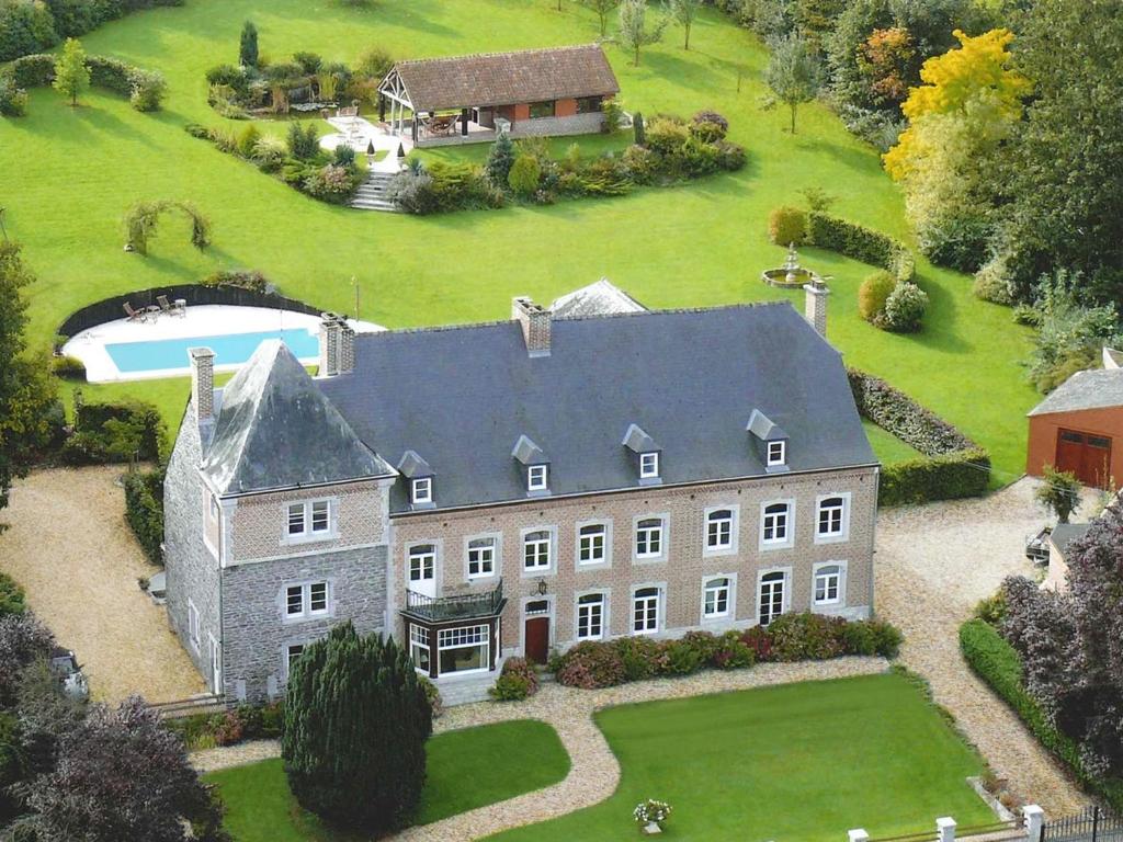 an aerial view of a large house with a yard at Le Richmond in Godinne