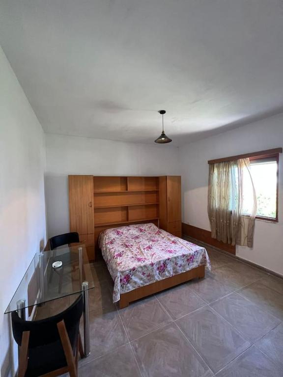 a bedroom with a bed and a glass table at Xhuljan apartament in Golem