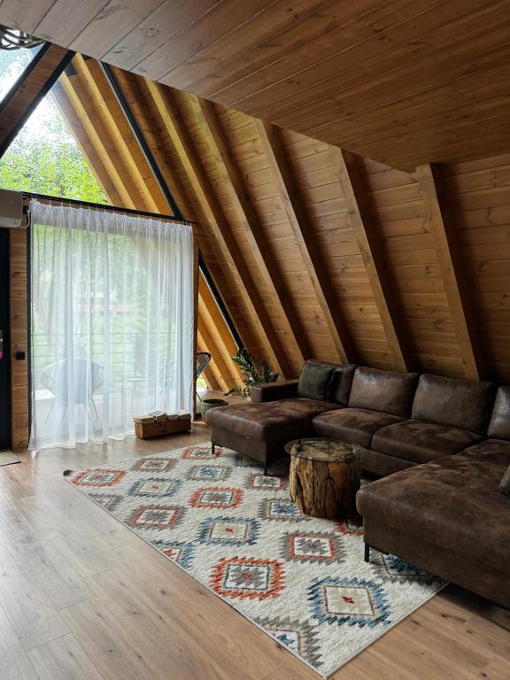 a living room with a couch and a rug at Cervus Magura in Măgura