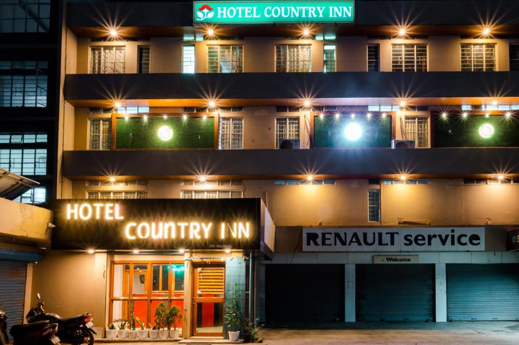 a hotel at night with lights in front of it at HOTEL COUNTRY INN in Dimāpur