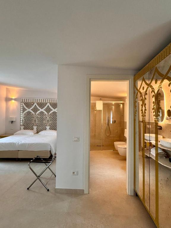 Postel nebo postele na pokoji v ubytování Hotel Rufolo