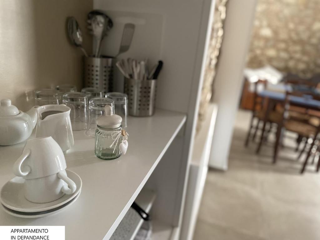 a white table with glasses on top of it at Tenute Plaia Agriturismo in Scopello