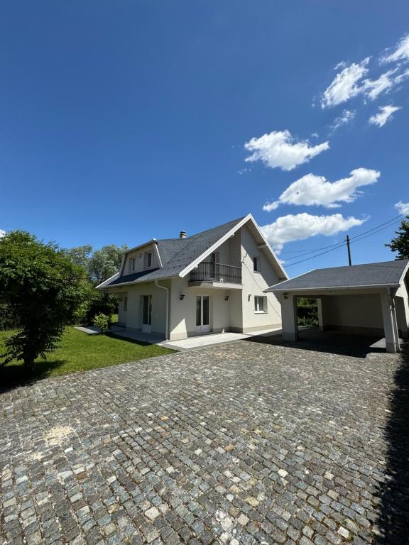 a large white house with a driveway at Villa Osik in Sarajevo
