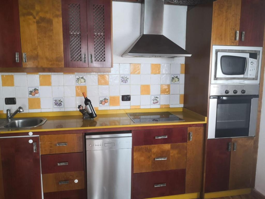 a kitchen with a sink and a stove top oven at Casa Umbría in Valsequillo