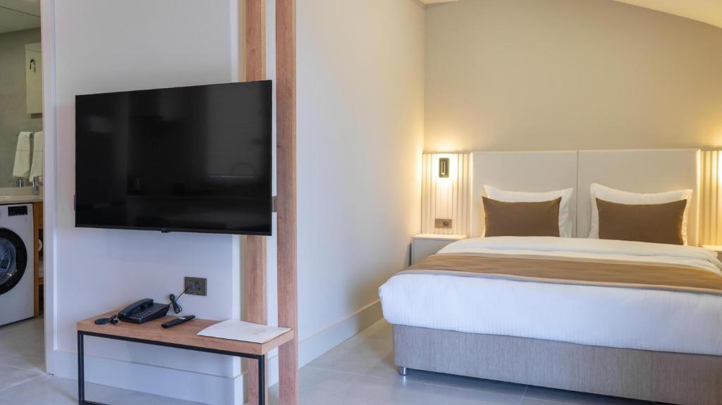 Postel nebo postele na pokoji v ubytování Bomo Suites