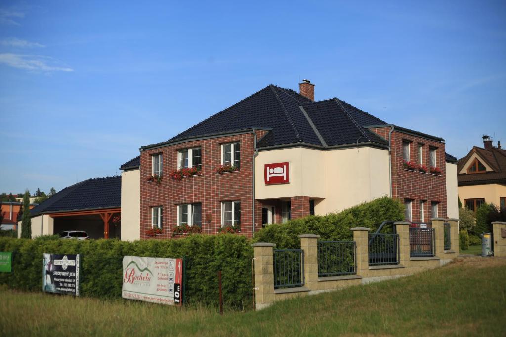 a large house with a fence in front of it at Penzion Bocheta in Nový Jičín