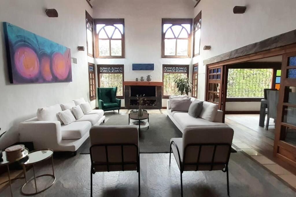 una sala de estar con sofás y sillas blancos en Spain style country house in Cajica, en Cajicá