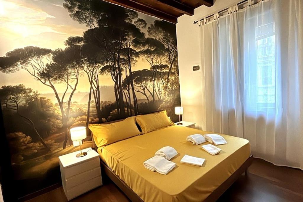 a bedroom with a bed with a painting on the wall at Marghera Botanical - Intero appartamento 50m2 in Milan