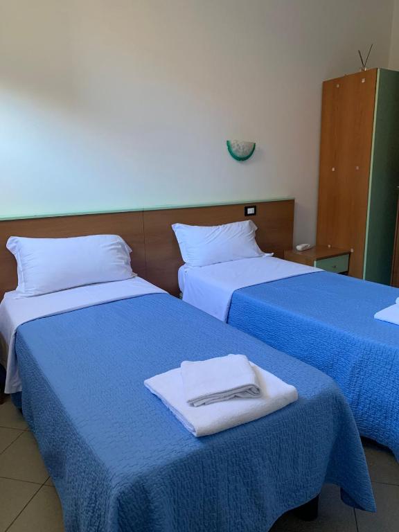 Postel nebo postele na pokoji v ubytování Hotel Mercurio
