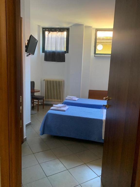 Postel nebo postele na pokoji v ubytování Hotel Mercurio