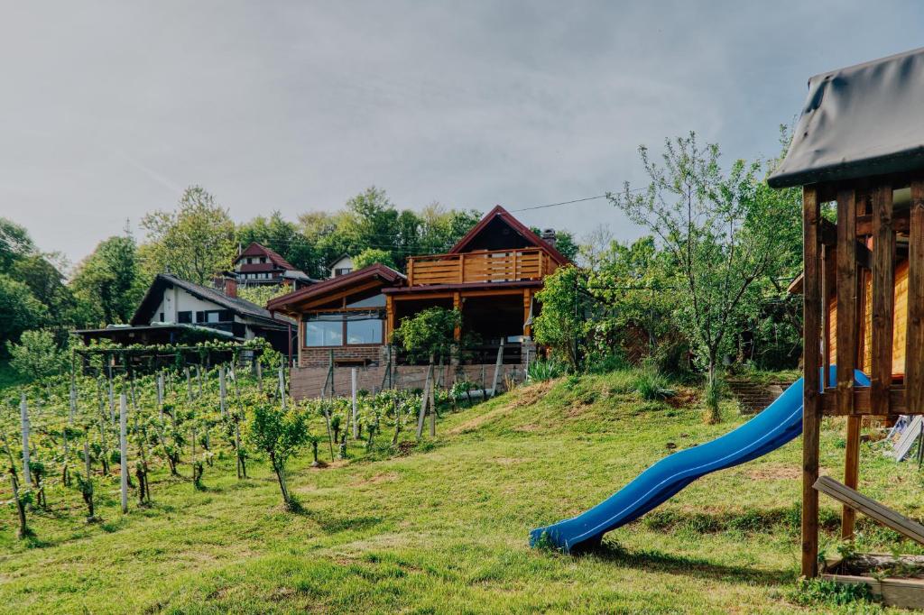 a playground with a slide in front of a house at Apartment Pri Braceku - Odmor u prirodi - Nature Retreat & Relaxation in Samobor