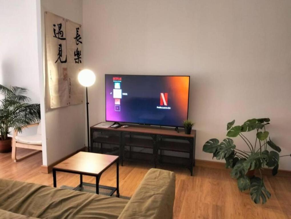 a living room with a flat screen tv on a stand at 03 Palazio Apartment Japanese style Studio Mount Austin Wifi & Netflix in Johor Bahru