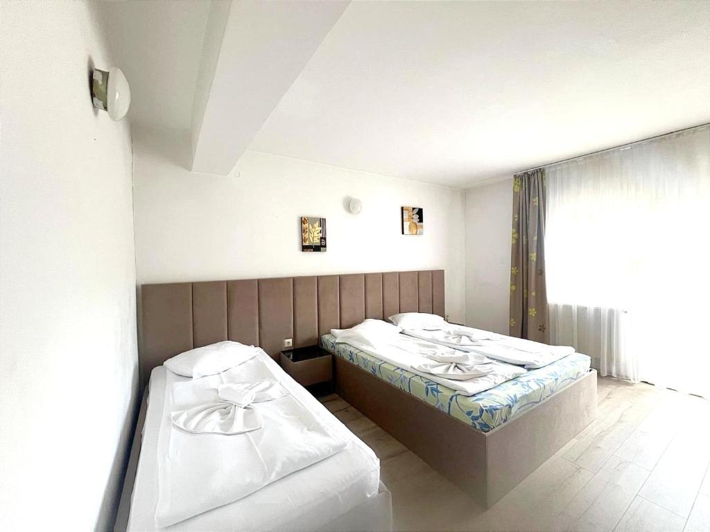 Postel nebo postele na pokoji v ubytování Aigi Rooms Vila
