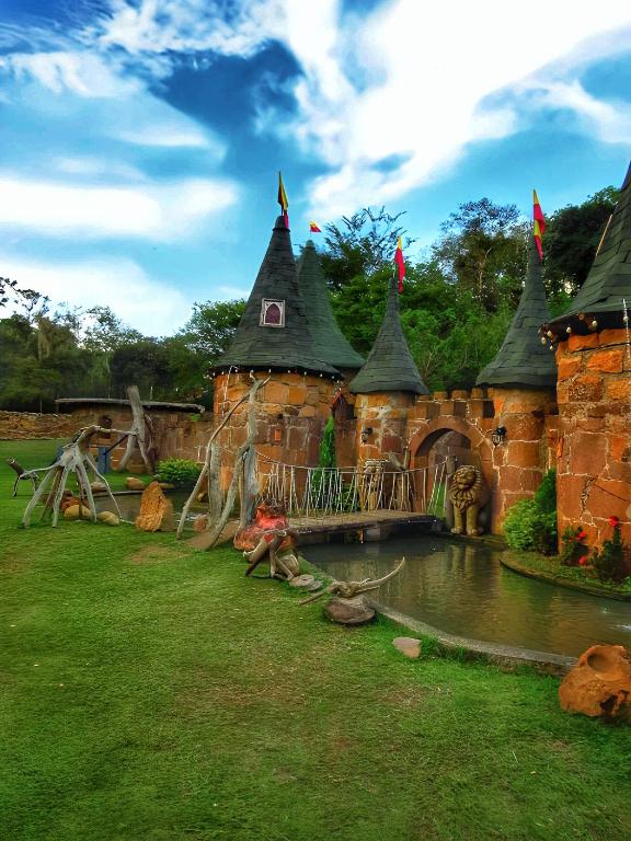 a large castle with a pond in a yard at Condado de Casa Grande in San Gil
