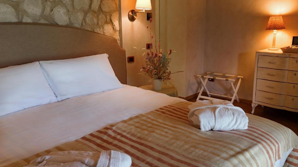 Postel nebo postele na pokoji v ubytování Relais La Magioca -Adults Only-
