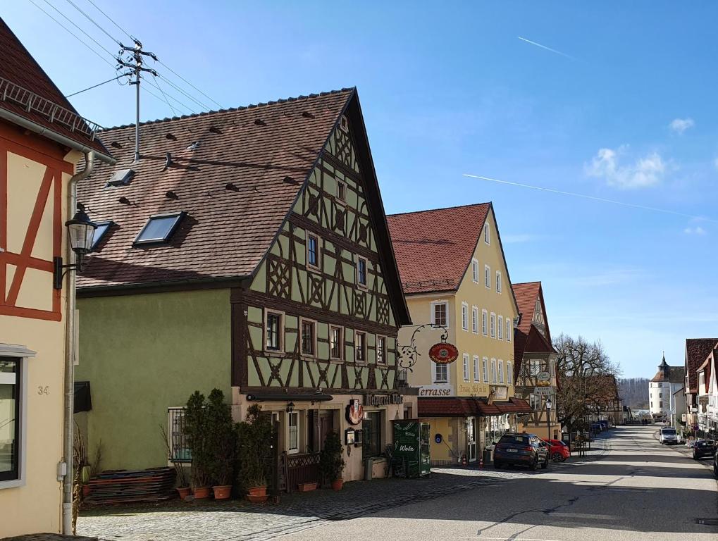 a group of buildings on a city street at Metzgerei und Pension Wolz in Langenburg
