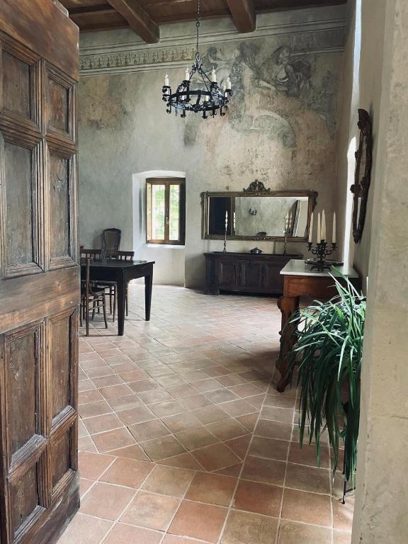 a large room with a table and a dining room at Palazzo Pirro Dimora Storica in Acciano