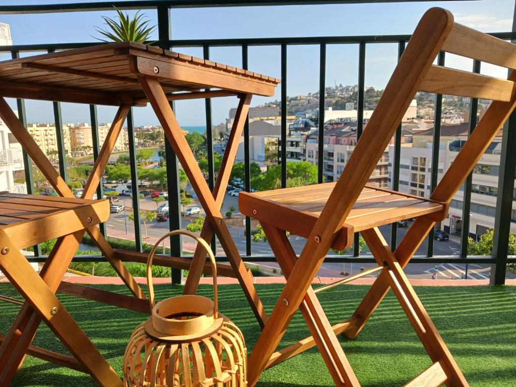 a wooden chair and table on a balcony at Peñiscola Playa FRENTE AL MAR in Peniscola