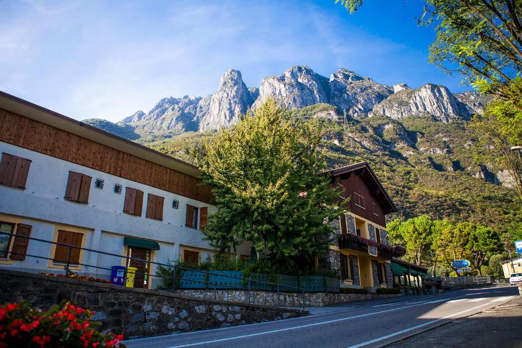 a street in a town with mountains in the background at La Baita in Boario Terme