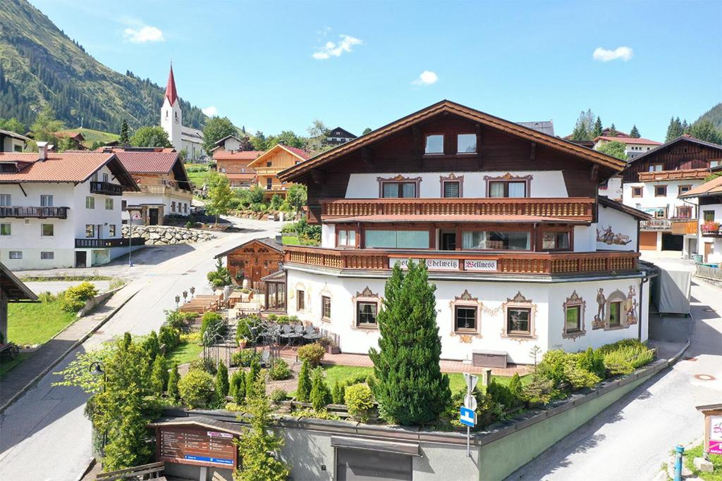 a large building in a town with a street at Hotel Edelweiẞ garni in Berwang