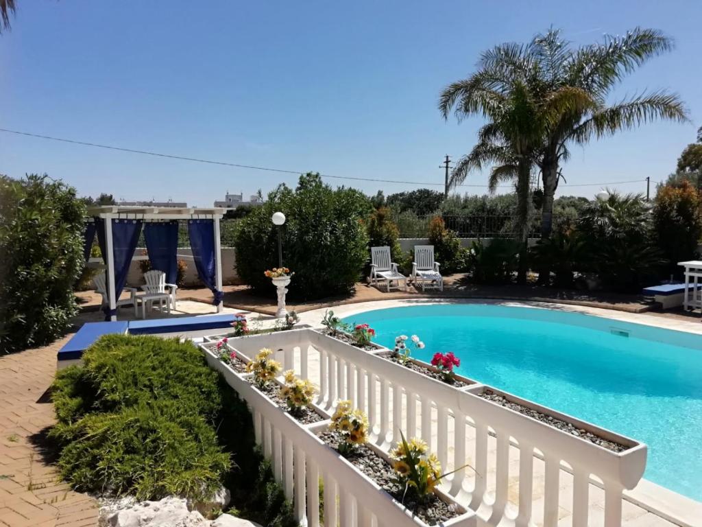a view of a swimming pool with a white fence and a white swimming poolintend at Sole&Mare in Monopoli