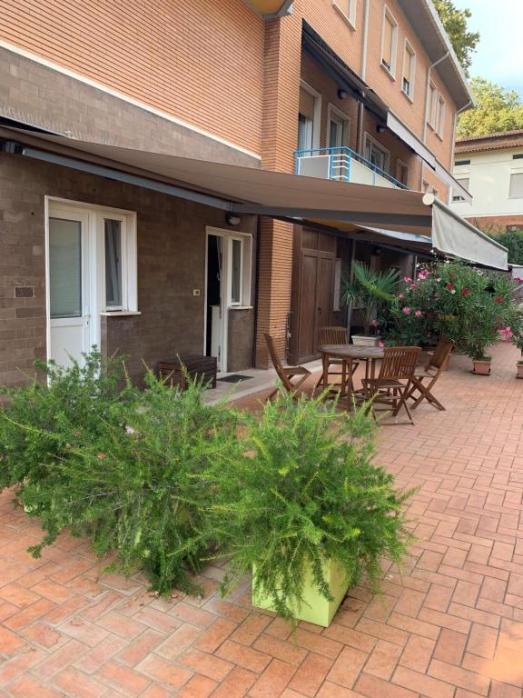 a patio with a table and chairs and plants at Casalago in Bolsena