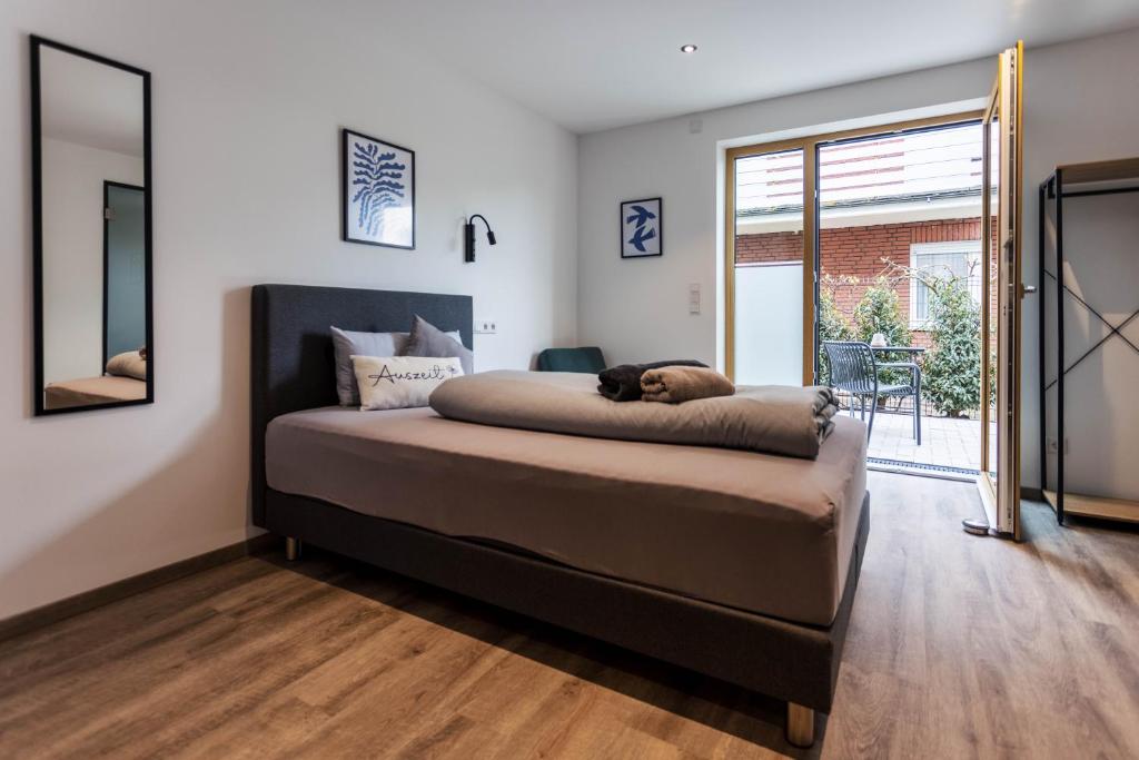 a bedroom with a bed with a dog laying on it at City-Apparte Boarding -Studios- Dein flexibles Zuhause in Gronau in Gronau