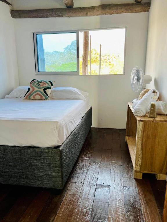 Postel nebo postele na pokoji v ubytování Itaca Eco House