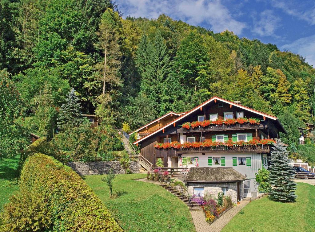 a house with flowers on the top of it at Gästehaus Bergwald in Berchtesgaden