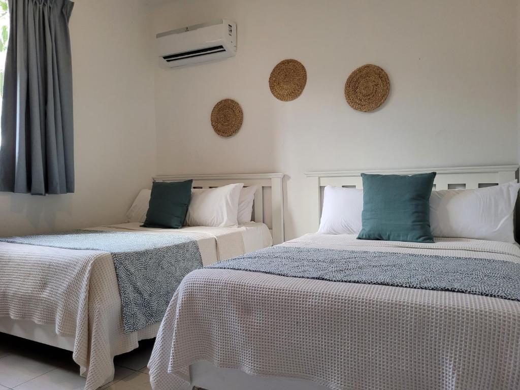dwa łóżka siedzące obok siebie w pokoju w obiekcie Drake Bolivar Santo Domingo w mieście Santo Domingo