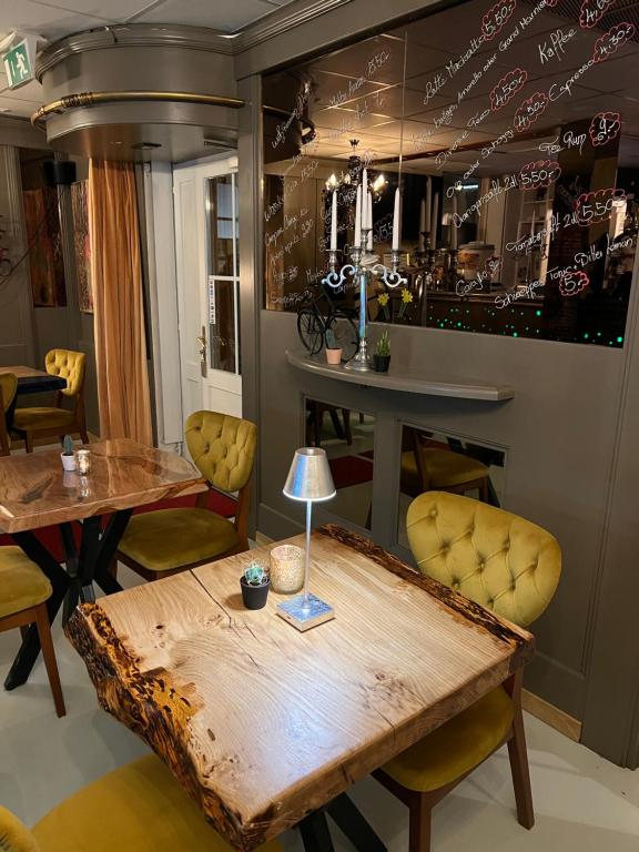 a dining room with a table and yellow chairs at Nydeck in Bern