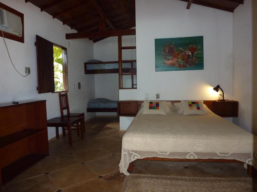 Ένα ή περισσότερα κρεβάτια σε δωμάτιο στο Pousada e Restaurante do Paulo