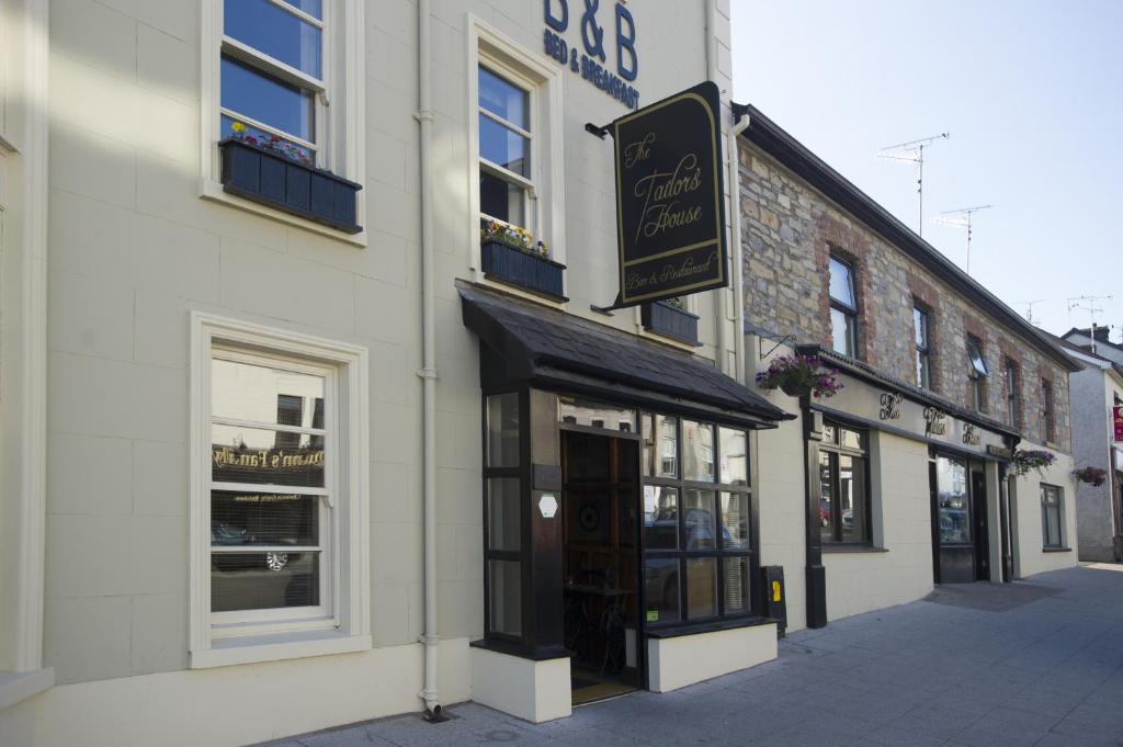 a building with a sign on the side of a street at The Tailor's House Guest Rooms in Dunmoyle