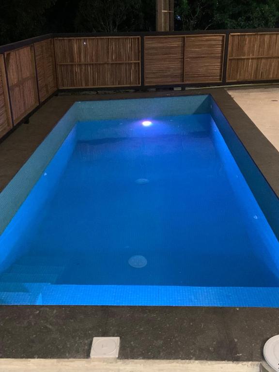 a large blue swimming pool at night at Casa De Descanso Feliz in Cancún