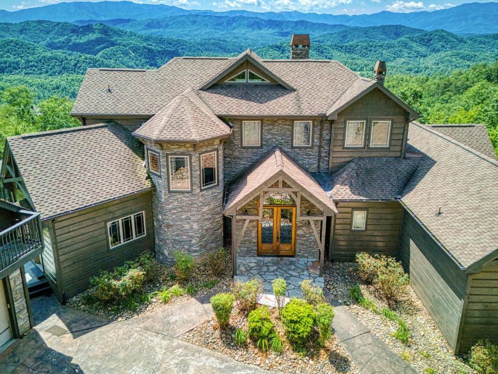 an aerial view of a house with mountains in the background at The King Of The Mountain - 6617 Sq Ft sleeps 22 amazing mountain views, Private Indoor Pool in Sevierville