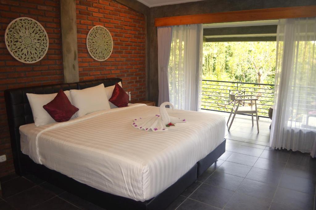 Voodi või voodid majutusasutuse Alamanda Lovina Resort toas