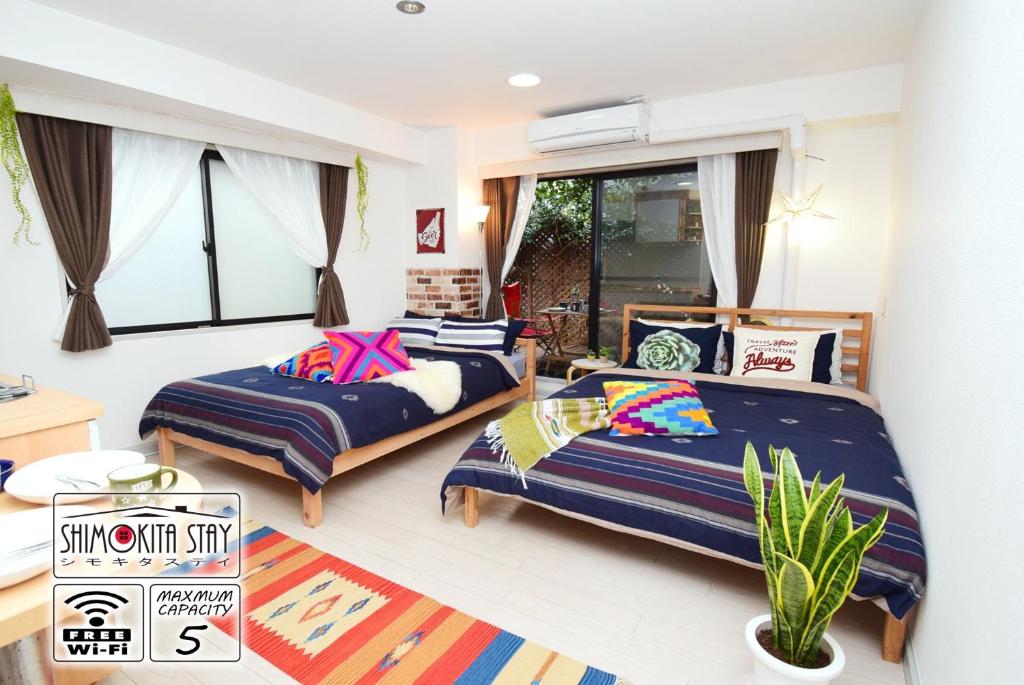 a bedroom with two beds and a window at KITAZAWA CS HOUSE / Vacation STAY 78552 in Tokyo