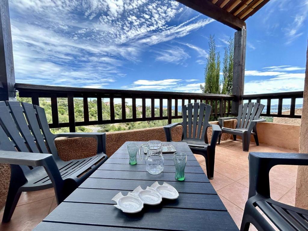 une table et des chaises sur une terrasse avec vue dans l'établissement Les Issambres 3 pièces, 4 pers, piscine, clim, parking - FR-1-226-548, à Roquebrune-sur Argens