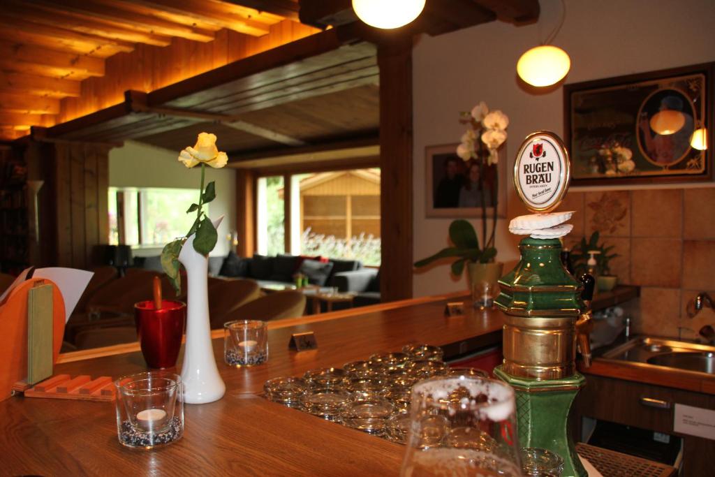 a table with a green bottle on top of it at Hotel Berghof Amaranth in Wilderswil