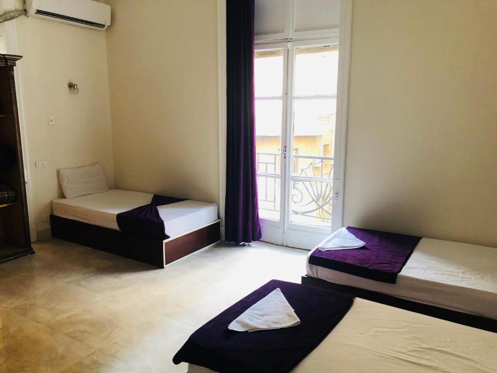 Postel nebo postele na pokoji v ubytování OH! Cairo Pharaoh Hostel